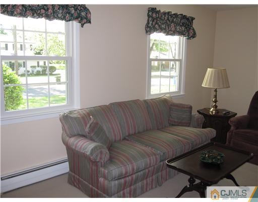 8 Woodruff Road Edison, NJ 08820 - Photo 8 of 21 a living room with furniture and a window