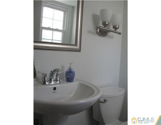 8 Woodruff Road Edison, NJ 08820 - Photo 9 of 21 a bathroom with a sink and a toilet