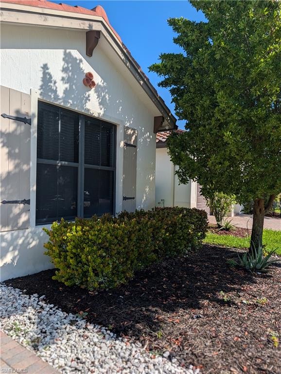 5518 Useppa Drive Ave Maria, FL 34142 - Photo 4 of 9 a front view of a house with garden