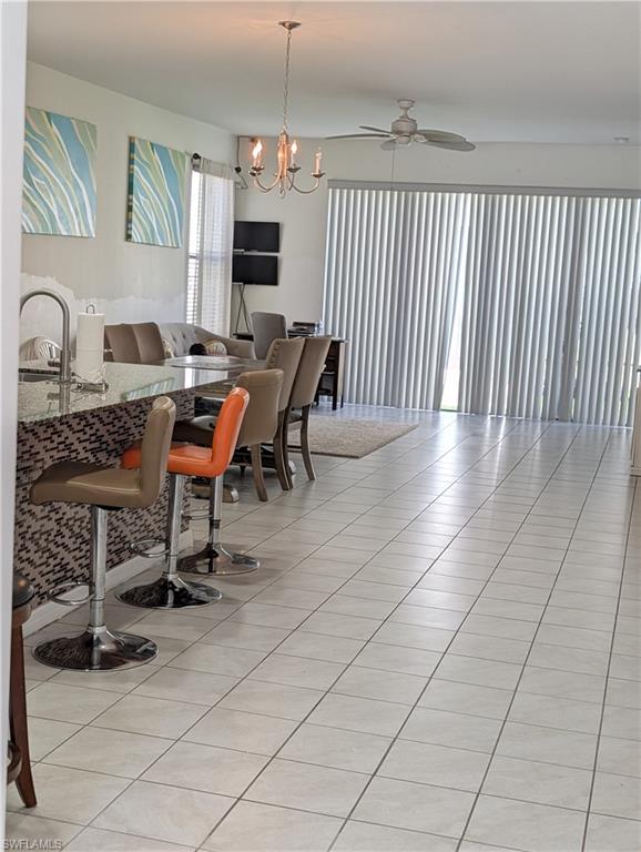 5518 Useppa Drive Ave Maria, FL 34142 - Photo 6 of 9 a dining room with furniture and a flat screen tv