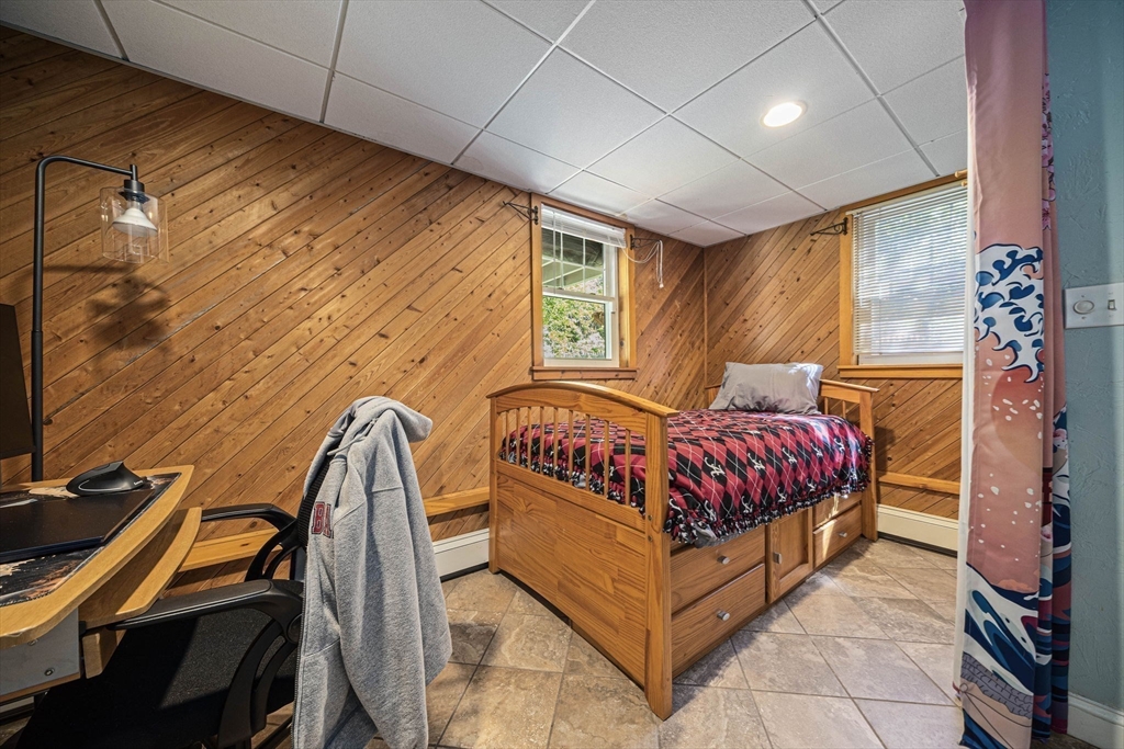 27 Plant Road Waltham, MA 02451 - Photo 16 of 31 a bedroom with a bed and a flat screen tv