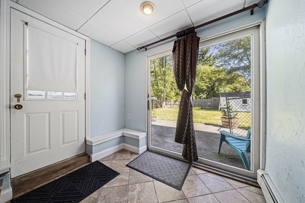 27 Plant Road Waltham, MA 02451 - Photo 20 of 31 a living room with a large window and a table