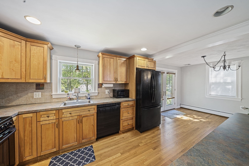 27 Plant Road Waltham, MA 02451 - Photo 5 of 31 a kitchen with stainless steel appliances a refrigerator sink and cabinets
