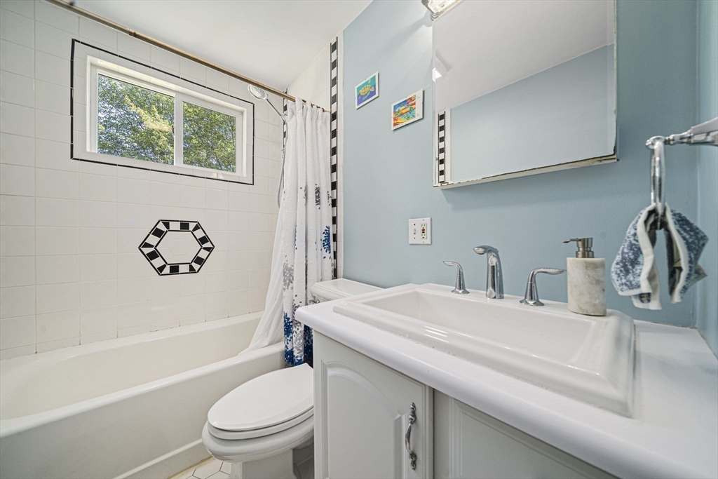 27 Plant Road Waltham, MA 02451 - Photo 9 of 31 a bathroom with a granite countertop sink toilet and a bathtub