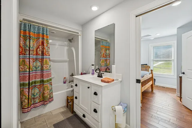 a living room with furniture and wooden floor