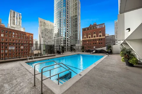 a view of swimming pool with outdoor seating