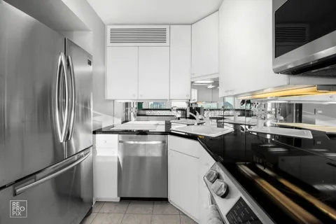 a kitchen with a sink stainless steel appliances and cabinets