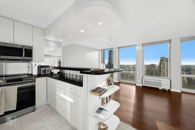 a kitchen with a sink appliances and cabinets
