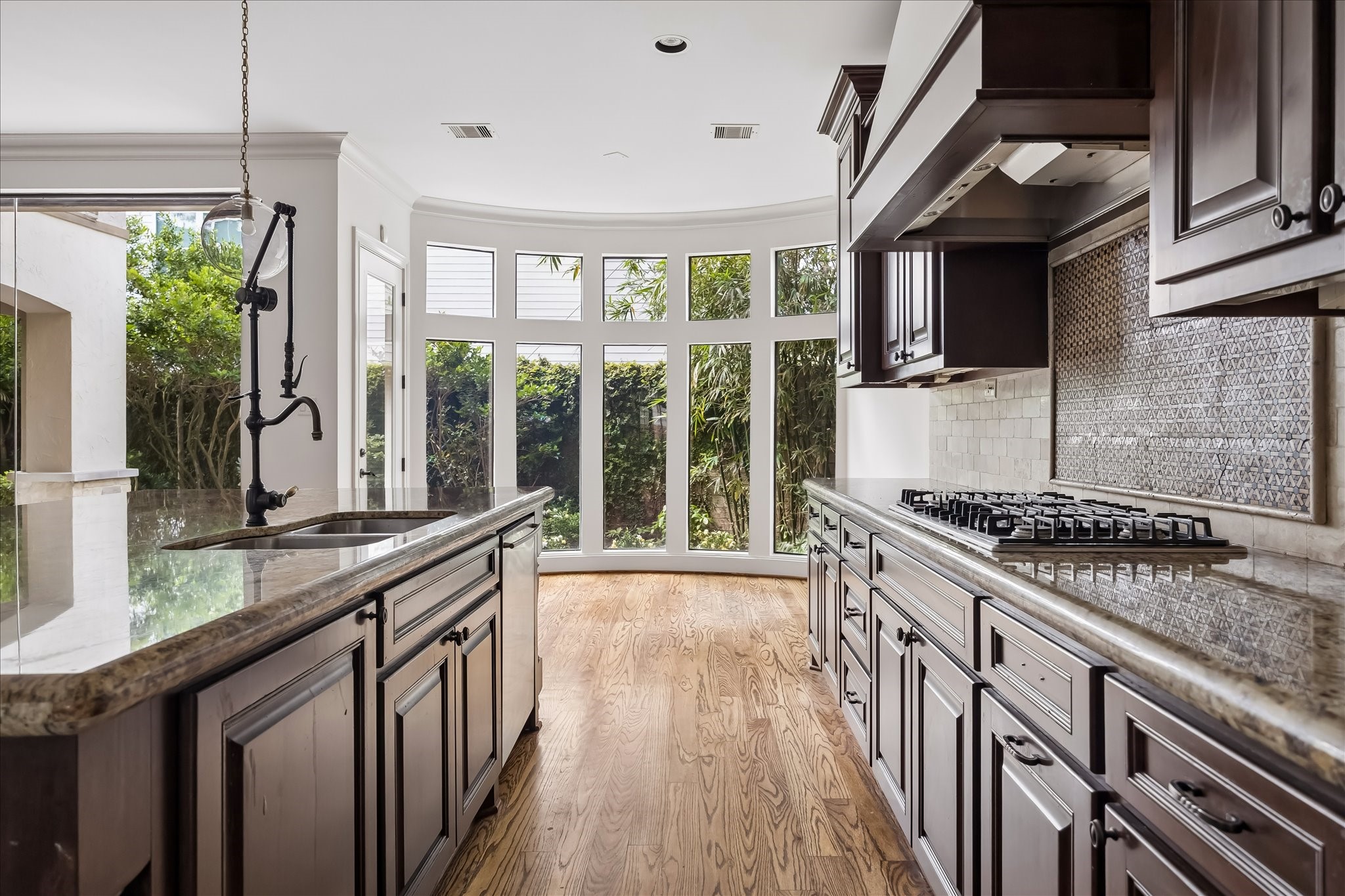 2246 Branard Street Houston, TX 77098 - Photo 10 of 40 Picture windows frame the breakfast area, bringing natural light and garden views into the kitchen.