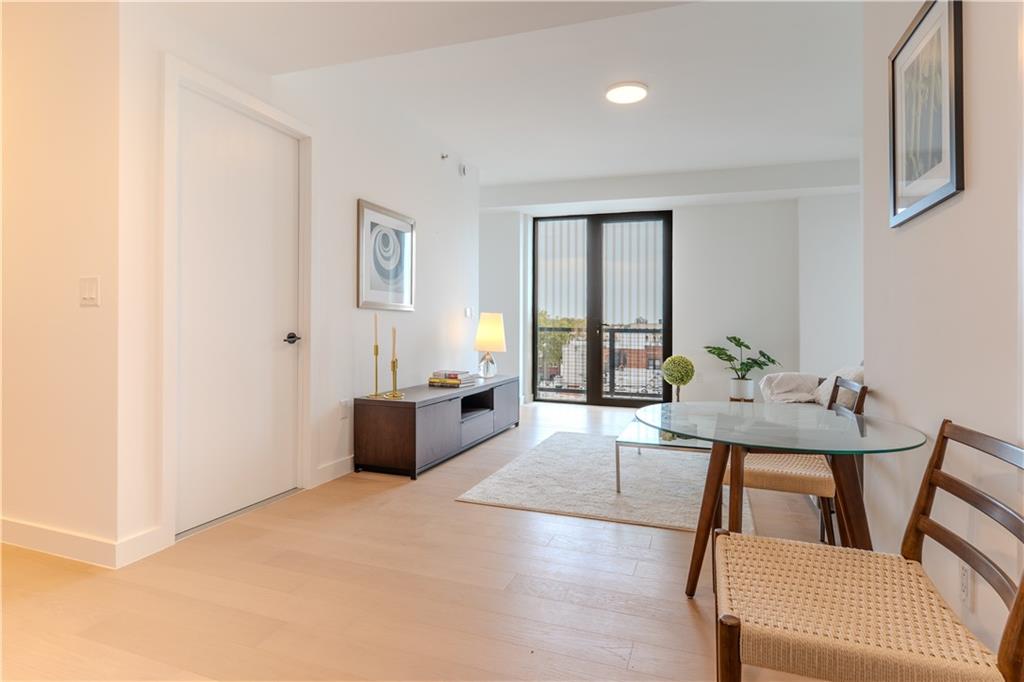 1807 66th Street, Unit 7A Brooklyn, NY 11204 - Photo 7 of 9 a living room with furniture and wooden floor