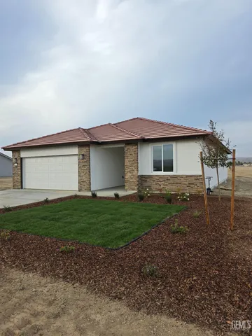 a view of a house with a yard and a garage