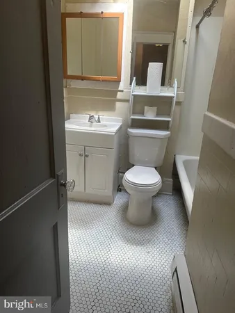 a bathroom with a toilet sink and mirror