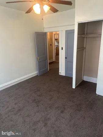 an empty room with closet area