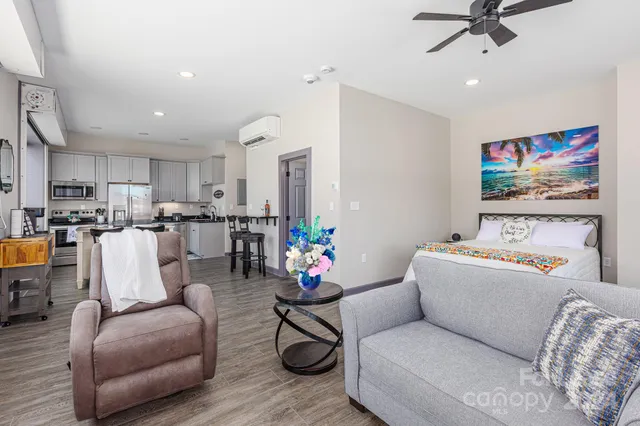a living room with furniture and kitchen view