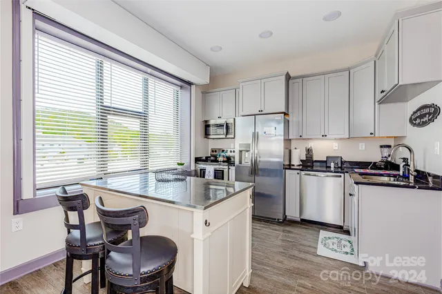 a kitchen with sink cabinets and dining table