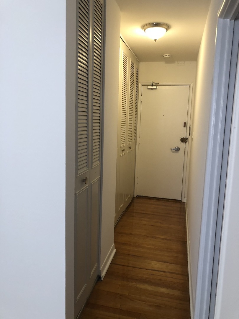 536 West Addison Street, Unit 391 Chicago, IL 60613 - Photo 5 of 6 a view of a hallway with wooden floor