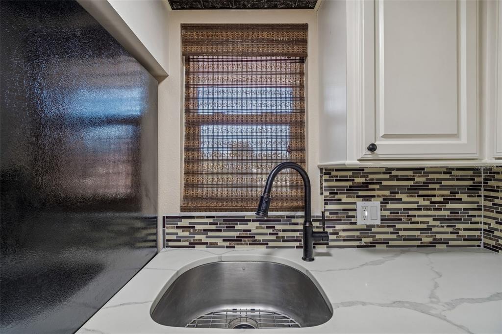 4937 Marine Parkway, Unit 105 New Port Richey, FL 34652 - Photo 11 of 50 a kitchen with a sink and cabinets