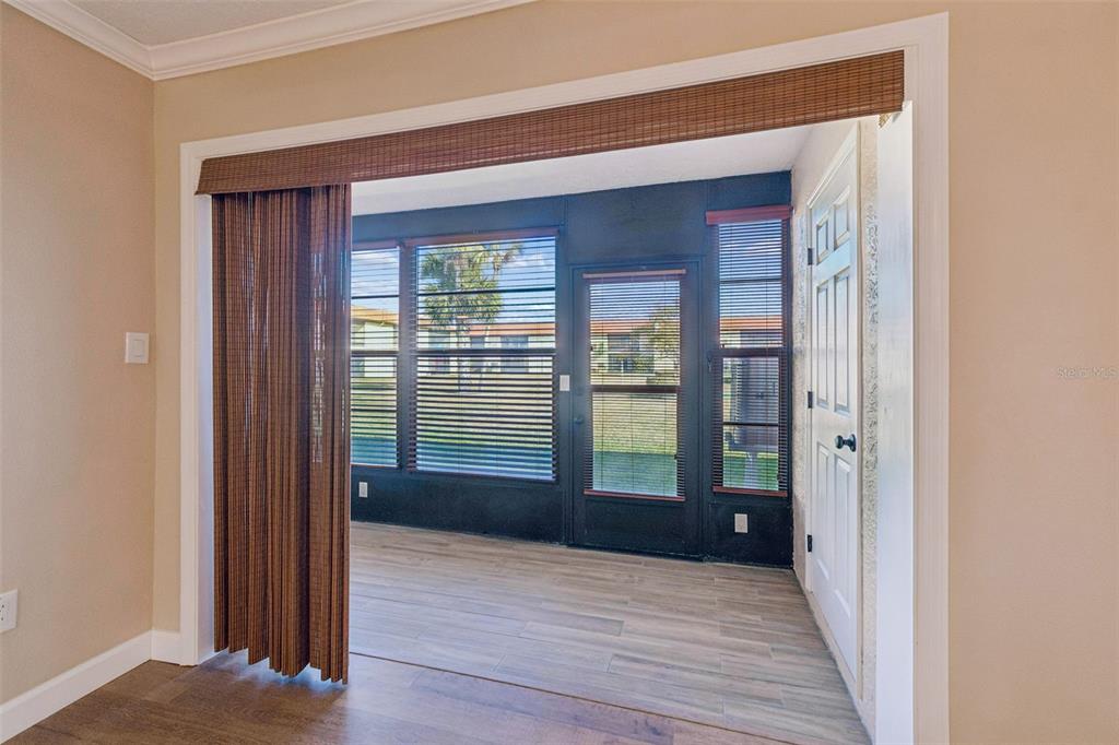 4937 Marine Parkway, Unit 105 New Port Richey, FL 34652 - Photo 15 of 50 a view of a hallway with wooden floor and a bathroom