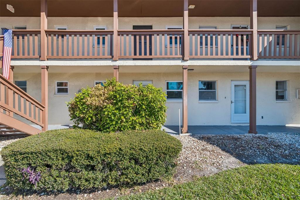 4937 Marine Parkway, Unit 105 New Port Richey, FL 34652 - Photo 2 of 50 a front view of a house with a garden