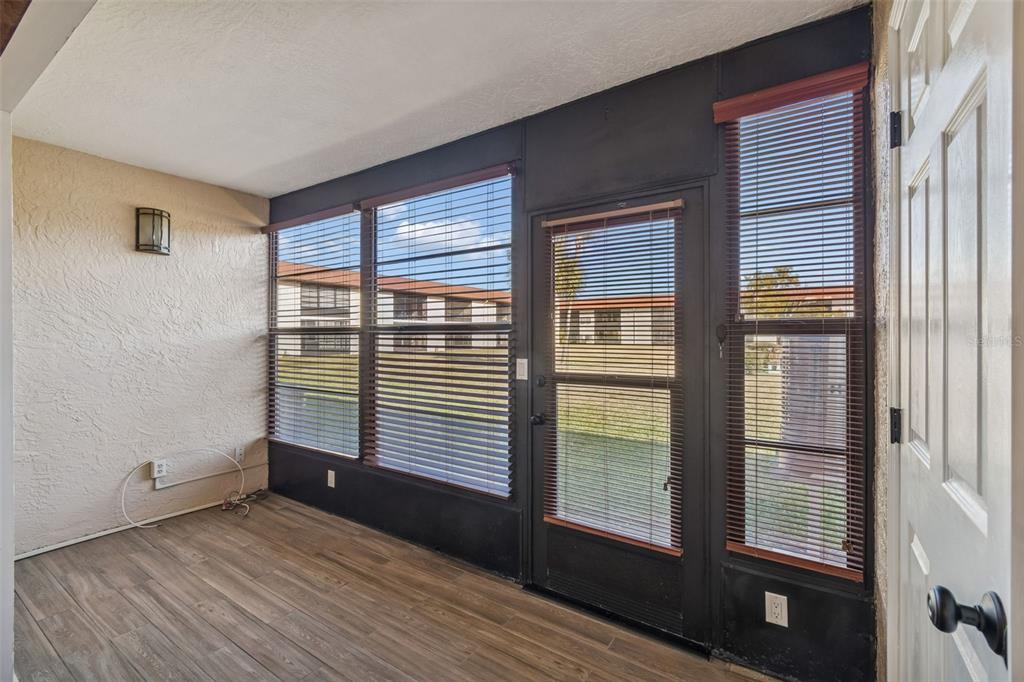 4937 Marine Parkway, Unit 105 New Port Richey, FL 34652 - Photo 24 of 50 a view of an empty room with wooden floor and a window