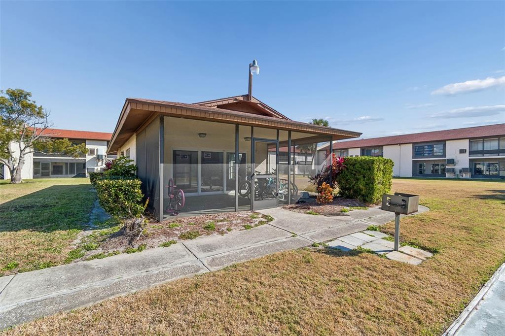 4937 Marine Parkway, Unit 105 New Port Richey, FL 34652 - Photo 30 of 50 a front view of a house with garden