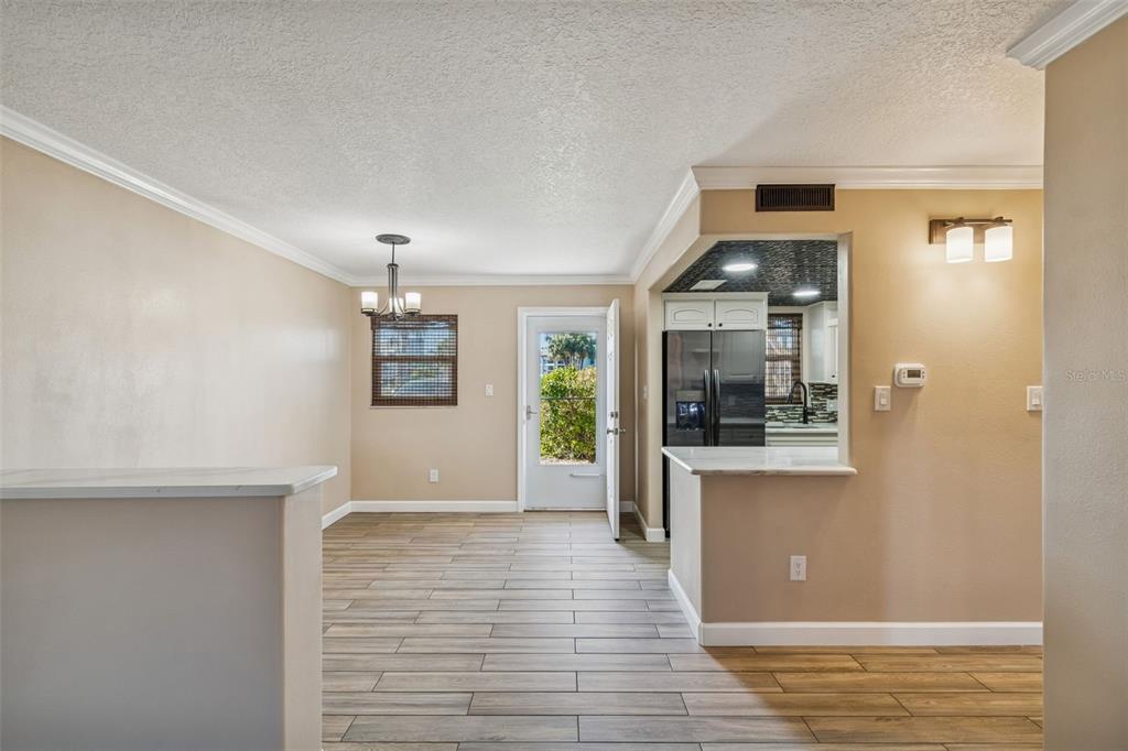 4937 Marine Parkway, Unit 105 New Port Richey, FL 34652 - Photo 3 of 50 a view of a hallway with wooden floor and a living room