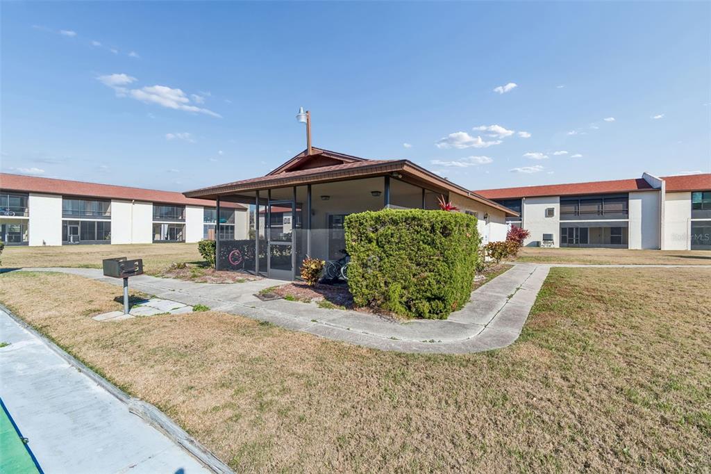 4937 Marine Parkway, Unit 105 New Port Richey, FL 34652 - Photo 32 of 50 a front view of a house with garden