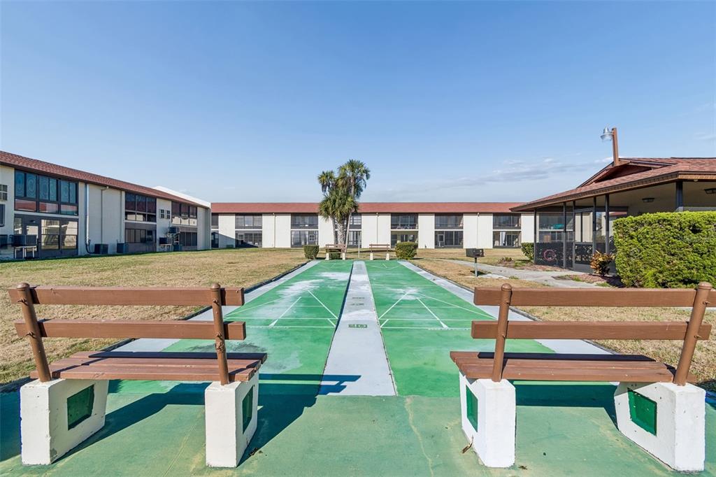 4937 Marine Parkway, Unit 105 New Port Richey, FL 34652 - Photo 33 of 50 a swimming pool with some trees in the background