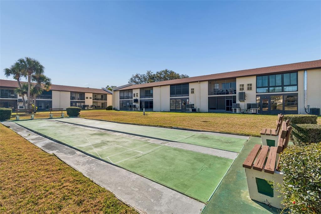 4937 Marine Parkway, Unit 105 New Port Richey, FL 34652 - Photo 34 of 50 a view of a house with swimming pool and sitting area