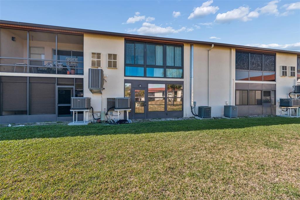 4937 Marine Parkway, Unit 105 New Port Richey, FL 34652 - Photo 36 of 50 a view of a house with a yard and sitting area