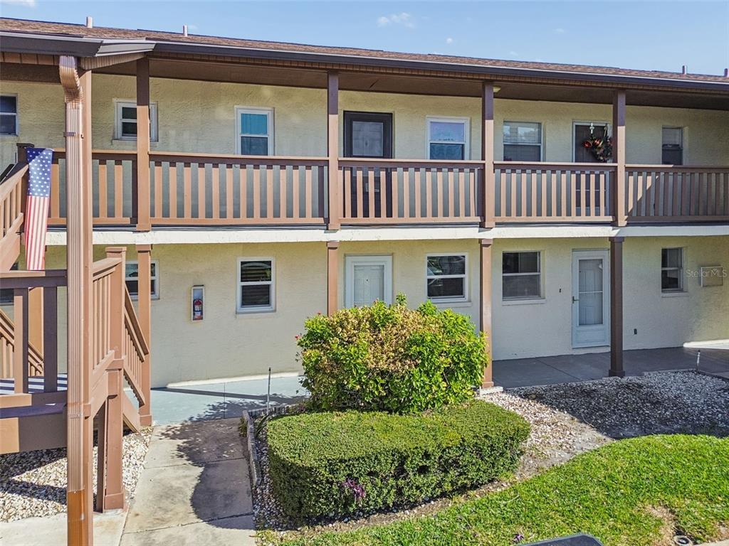 4937 Marine Parkway, Unit 105 New Port Richey, FL 34652 - Photo 38 of 50 a front view of a house with a yard
