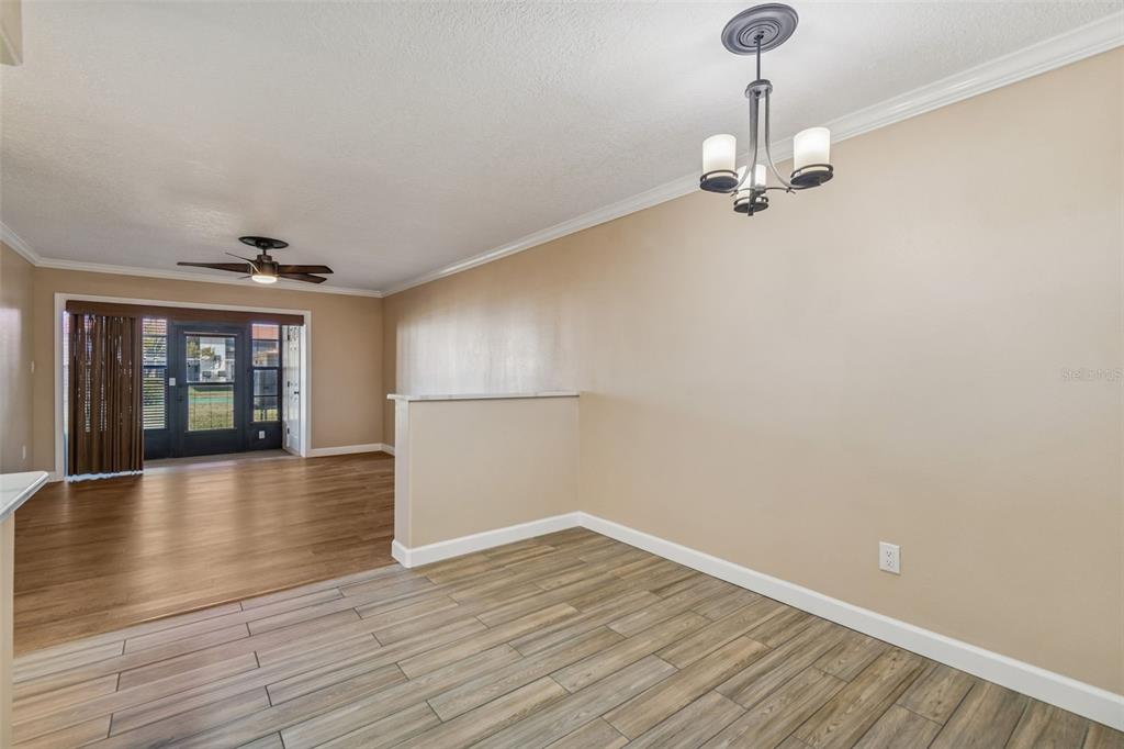 4937 Marine Parkway, Unit 105 New Port Richey, FL 34652 - Photo 4 of 50 wooden floor in an empty room with a window