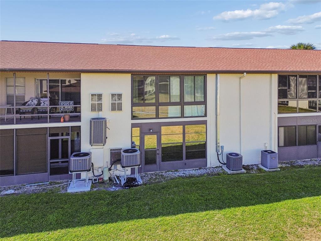 4937 Marine Parkway, Unit 105 New Port Richey, FL 34652 - Photo 48 of 50 a front view of house with yard and outdoor seating