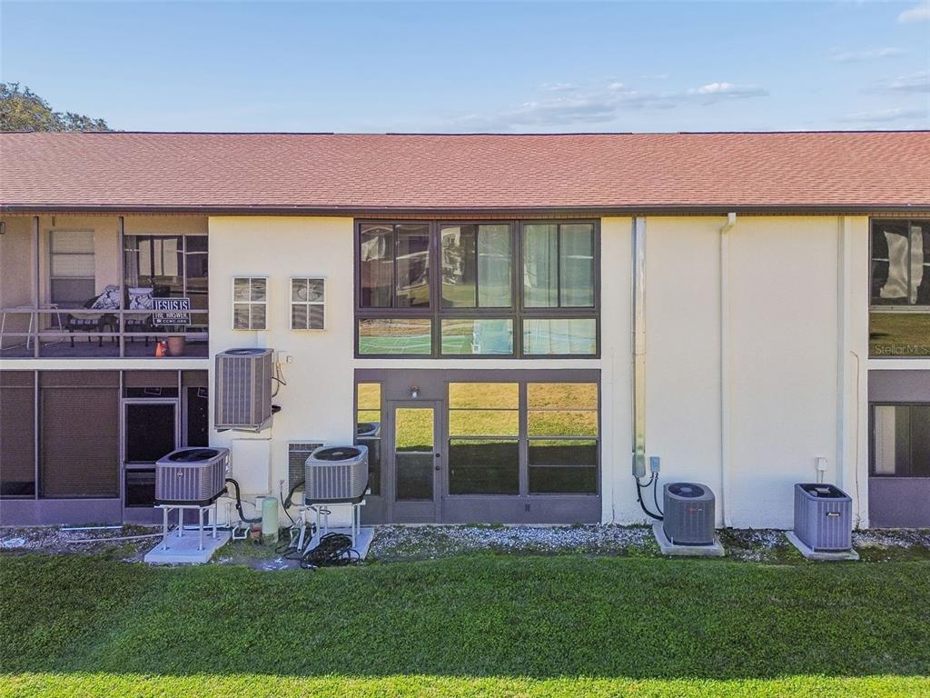 4937 Marine Parkway, Unit 105 New Port Richey, FL 34652 - Photo 49 of 50 a front view of a house with a yard table and chairs