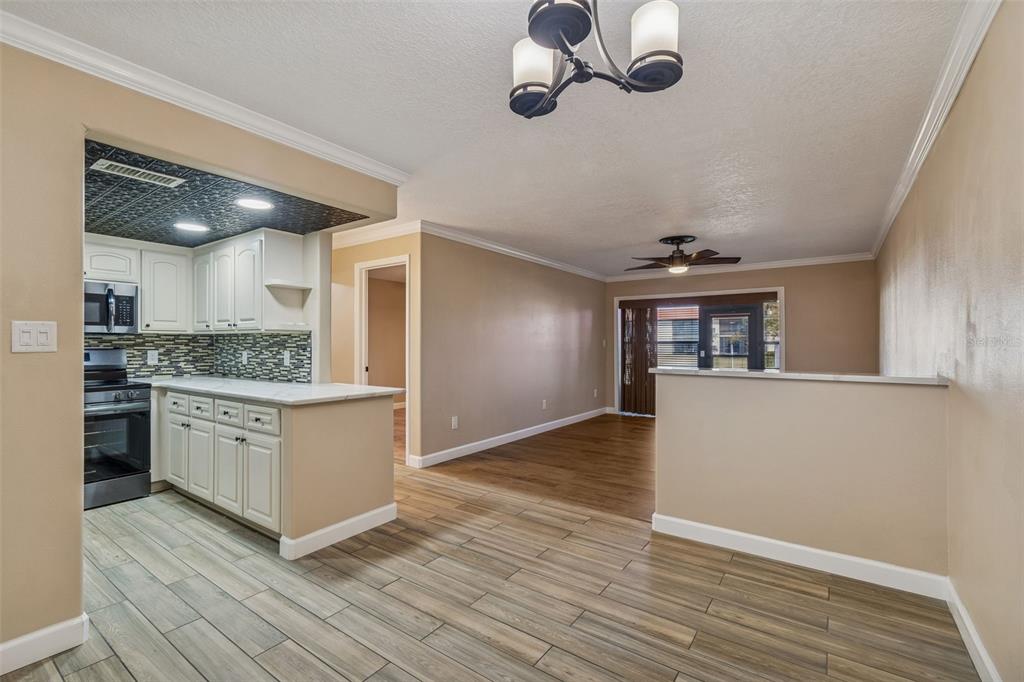 4937 Marine Parkway, Unit 105 New Port Richey, FL 34652 - Photo 5 of 50 a hallway with cabinets and wooden floor