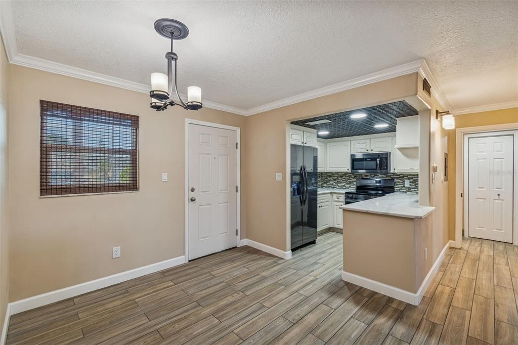 4937 Marine Parkway, Unit 105 New Port Richey, FL 34652 - Photo 6 of 50 a view of kitchen with sink microwave and refrigerator