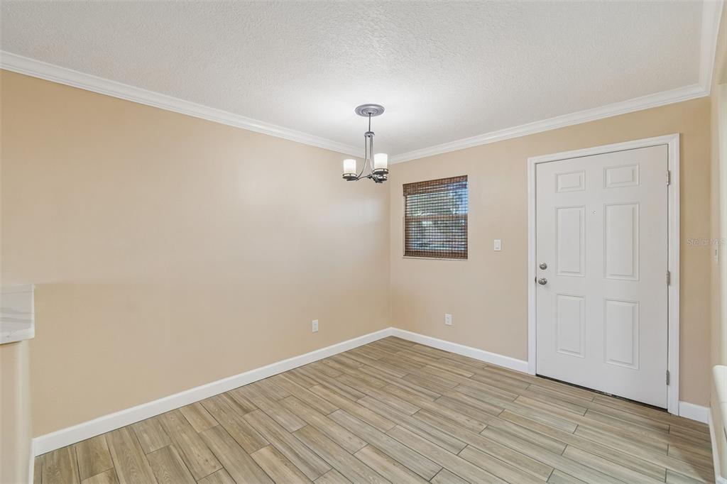4937 Marine Parkway, Unit 105 New Port Richey, FL 34652 - Photo 7 of 50 an empty room with wooden floor ceiling fan and windows