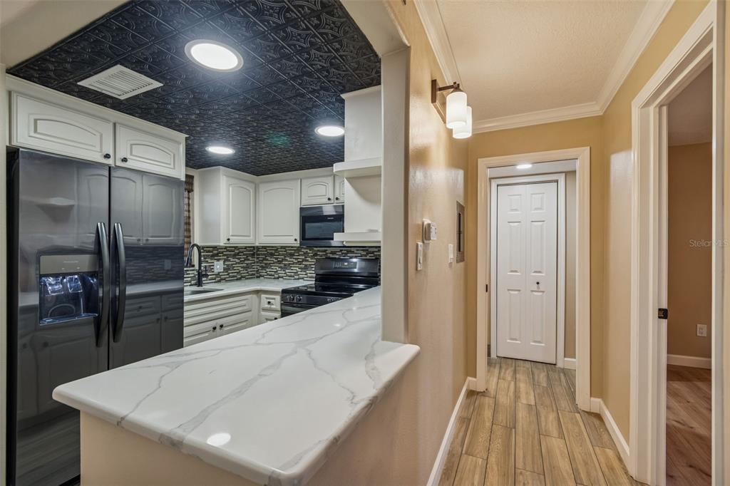 4937 Marine Parkway, Unit 105 New Port Richey, FL 34652 - Photo 8 of 50 a kitchen with stainless steel appliances a refrigerator and a stove