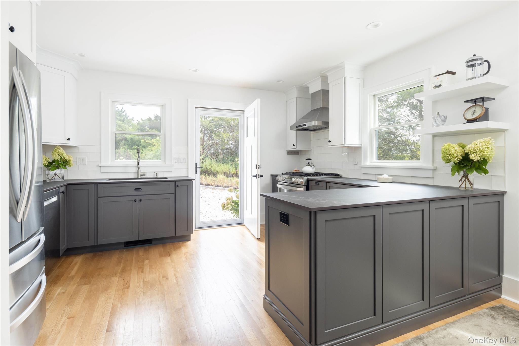 1260 Main Road Jamesport, NY 11901 - Photo 16 of 22 a kitchen with stainless steel appliances a sink cabinets and wooden floor