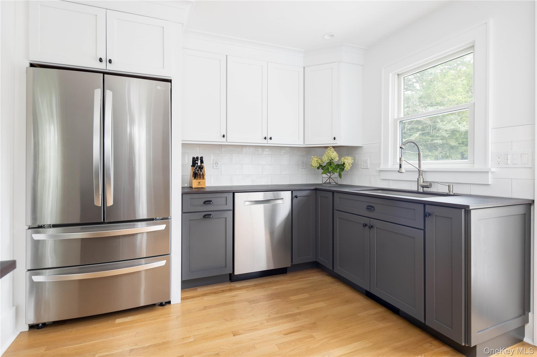 1260 Main Road Jamesport, NY 11901 - Photo 18 of 22 a kitchen with a refrigerator sink and window