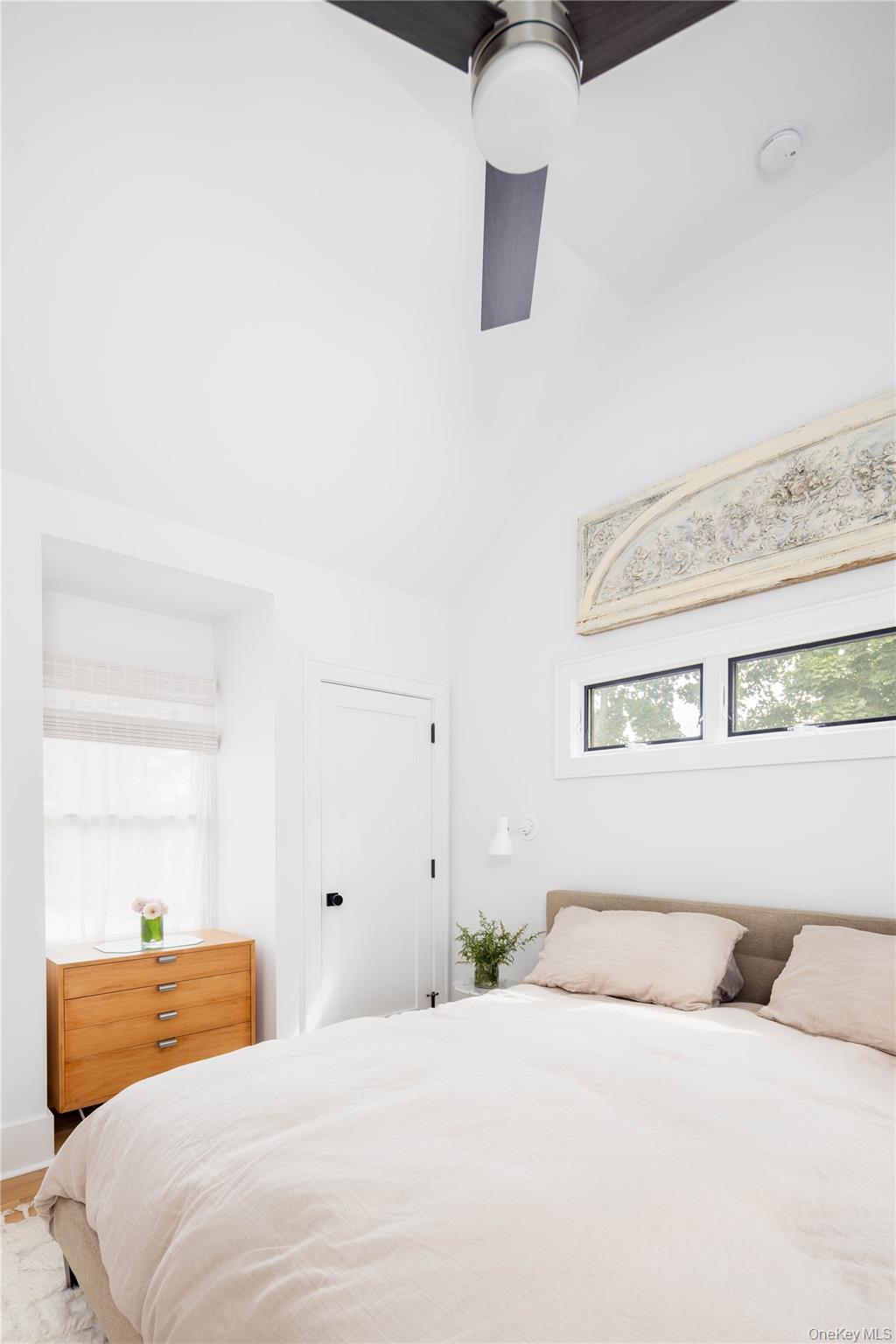 1260 Main Road Jamesport, NY 11901 - Photo 19 of 22 a bedroom with a bed and dresser with mirror