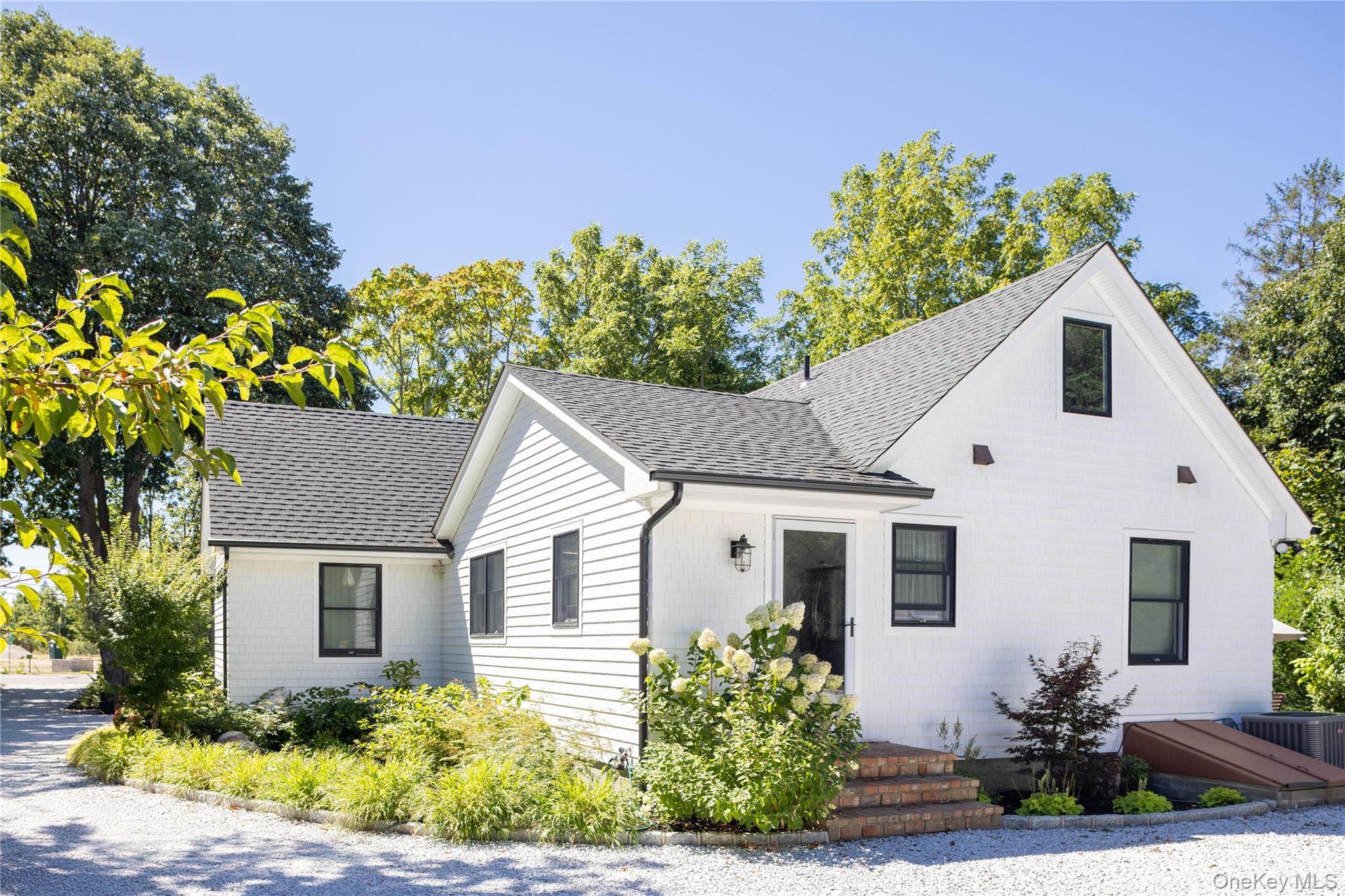 1260 Main Road Jamesport, NY 11901 - Photo 2 of 22 a front view of a house with a yard