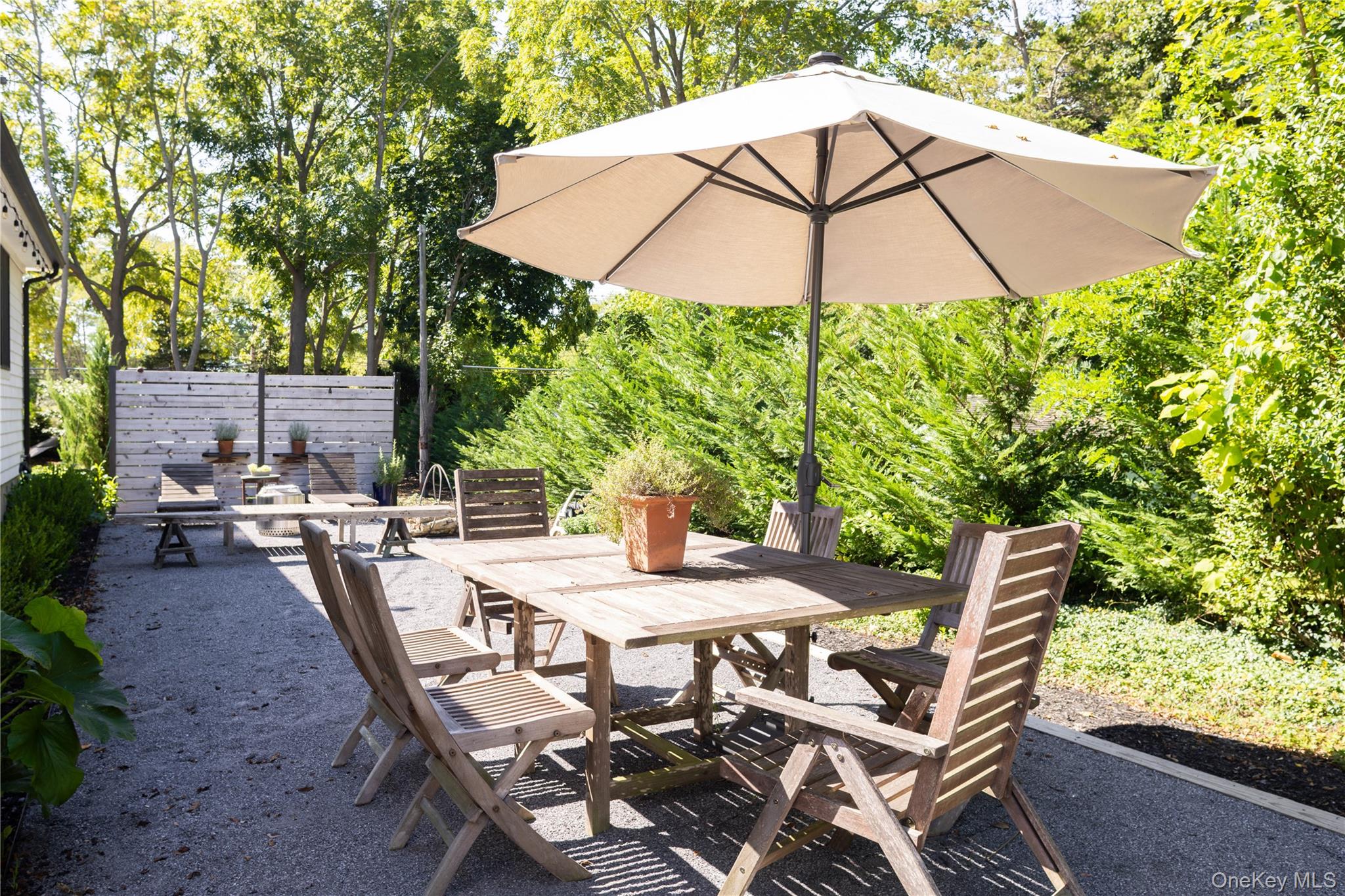1260 Main Road Jamesport, NY 11901 - Photo 5 of 22 a patio with a patio table and chairs