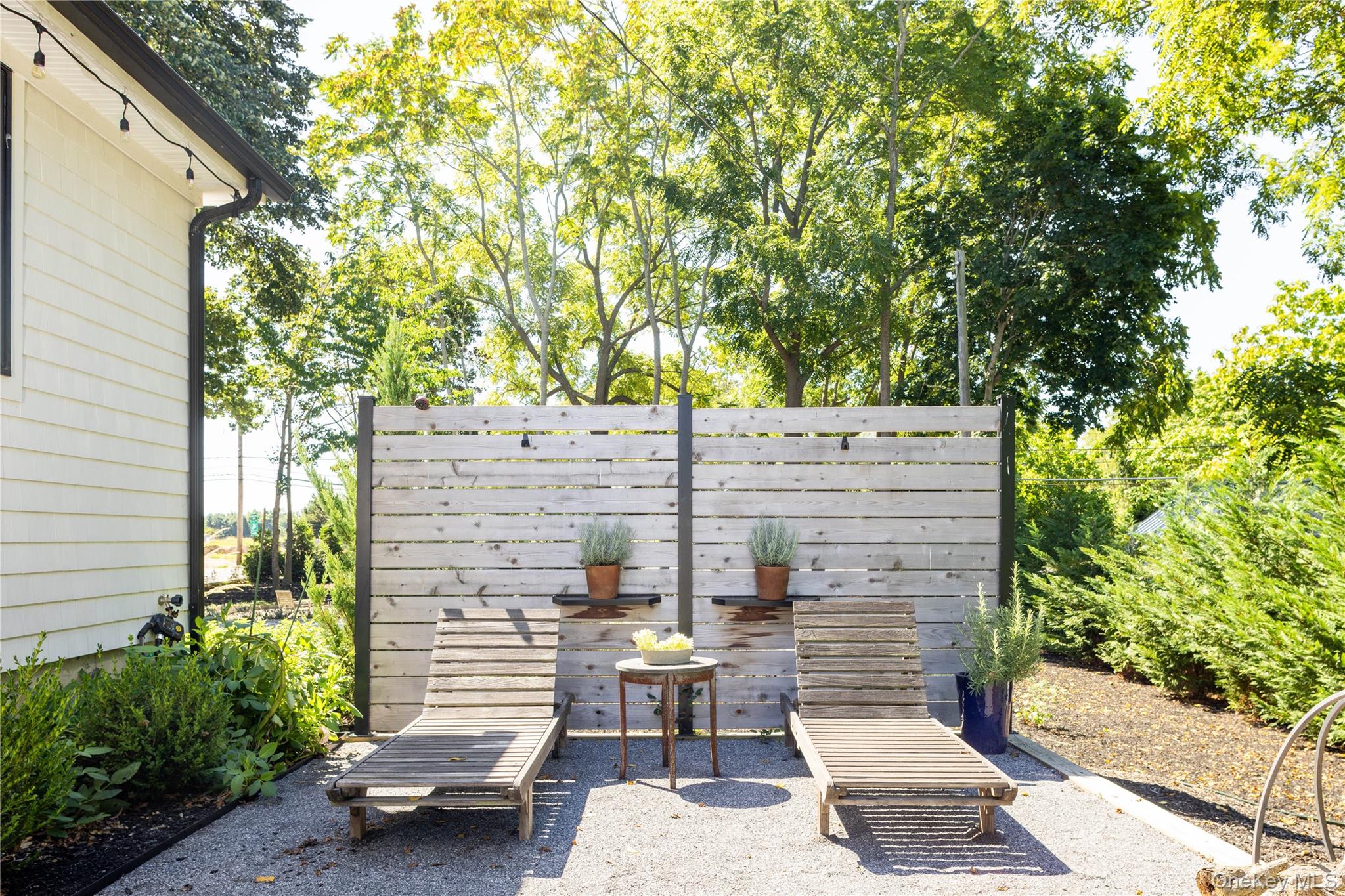 1260 Main Road Jamesport, NY 11901 - Photo 6 of 22 a view of a patio with table and chairs and potted plants