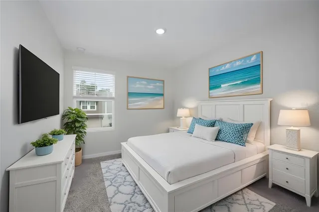 a bedroom with a large bed and a flat screen tv