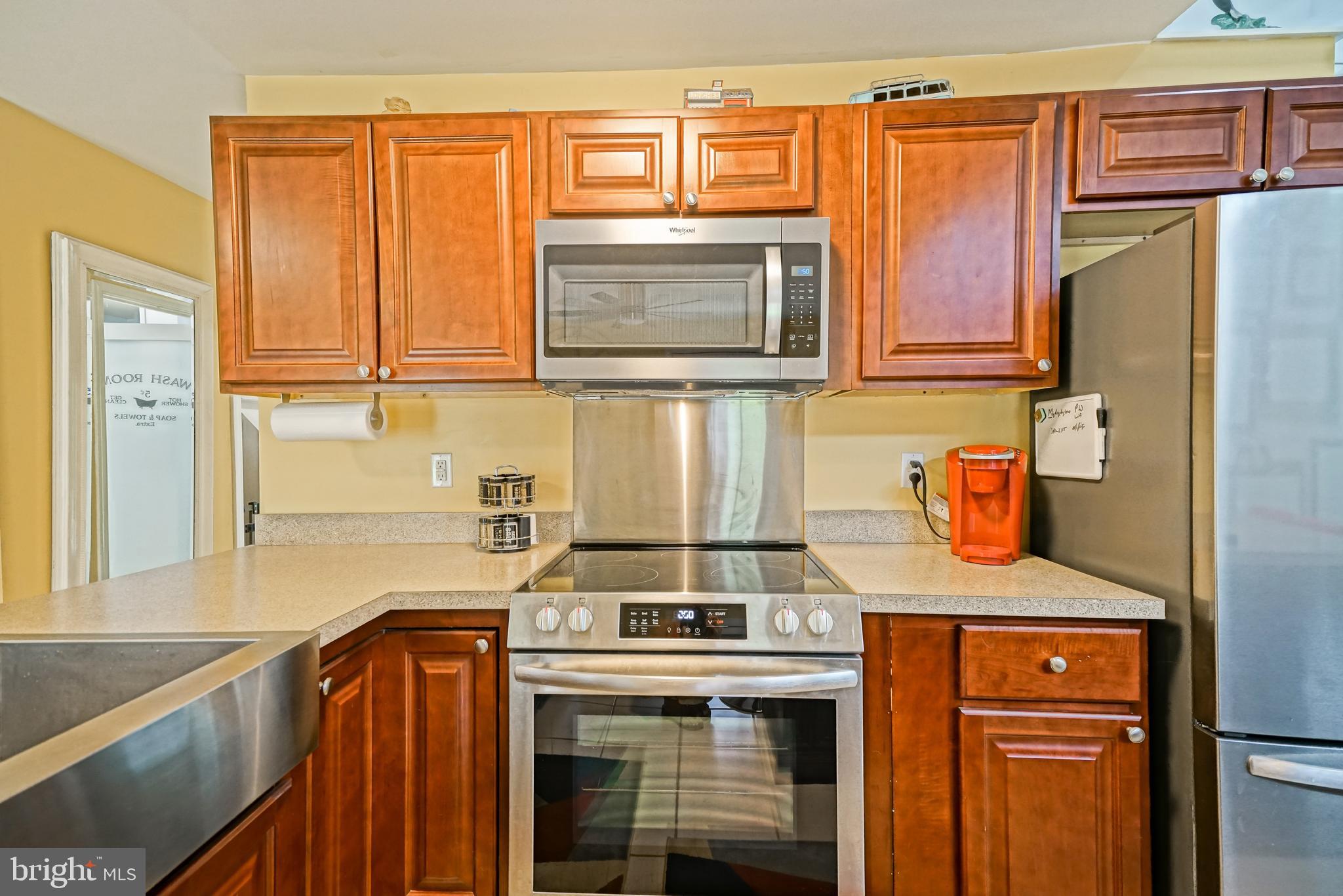 18897 Sand Hill Road Milton, DE 19968 - Photo 11 of 51 a kitchen with a sink stove and microwave