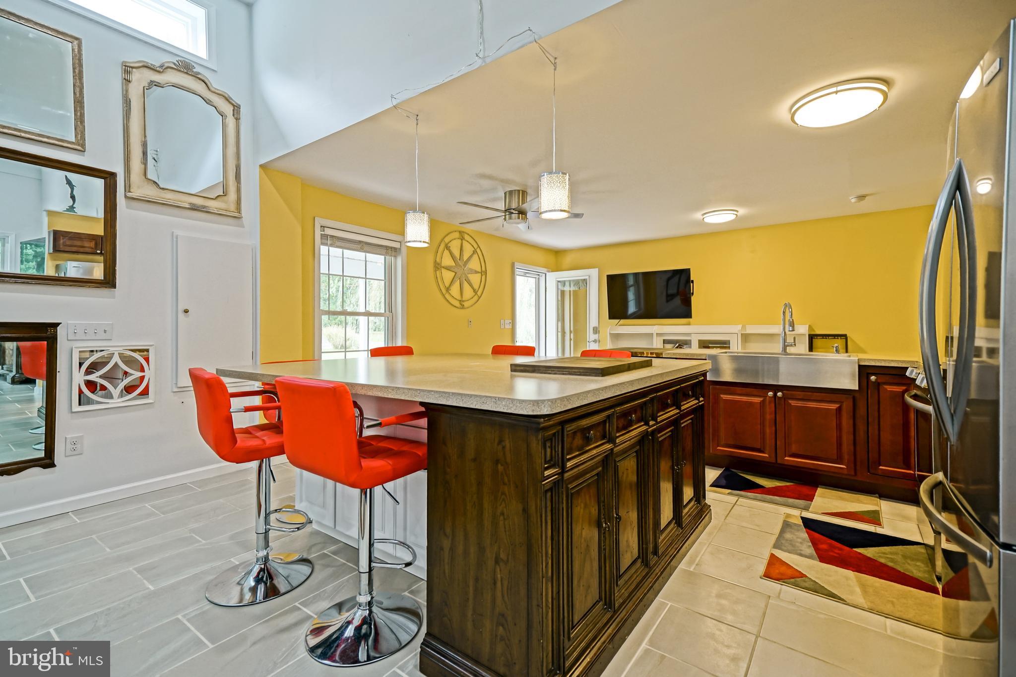 18897 Sand Hill Road Milton, DE 19968 - Photo 14 of 51 a kitchen with stainless steel appliances granite countertop a stove and a refrigerator