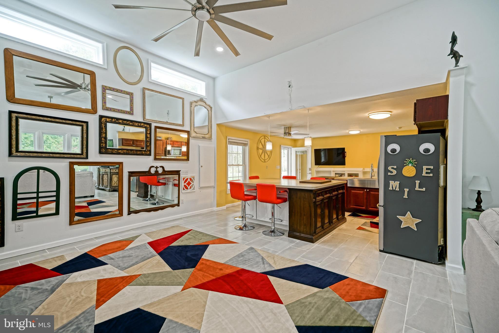 18897 Sand Hill Road Milton, DE 19968 - Photo 17 of 51 a living room with furniture a rug and a chandelier