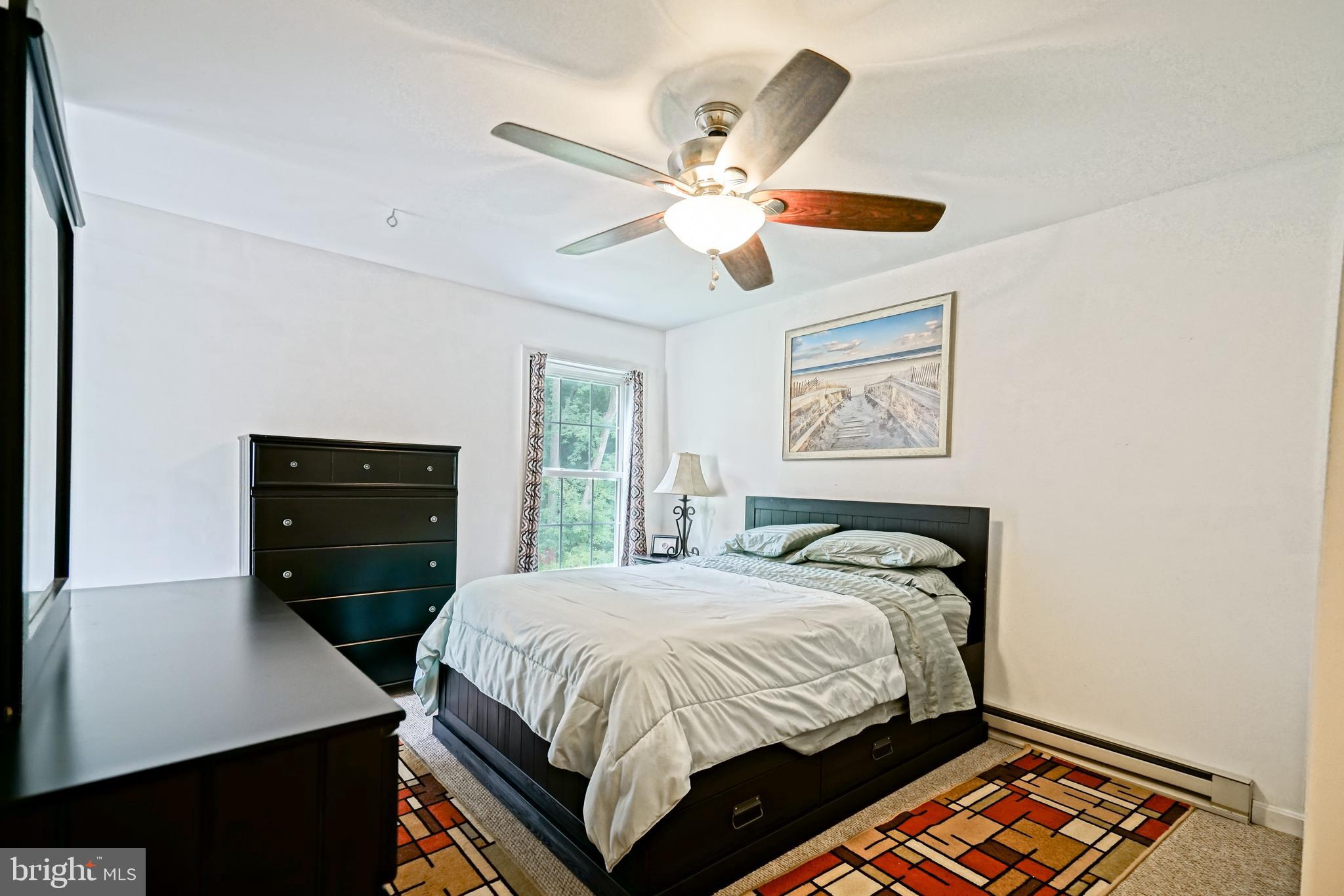 18897 Sand Hill Road Milton, DE 19968 - Photo 25 of 51 a bedroom with a bed and a chandelier