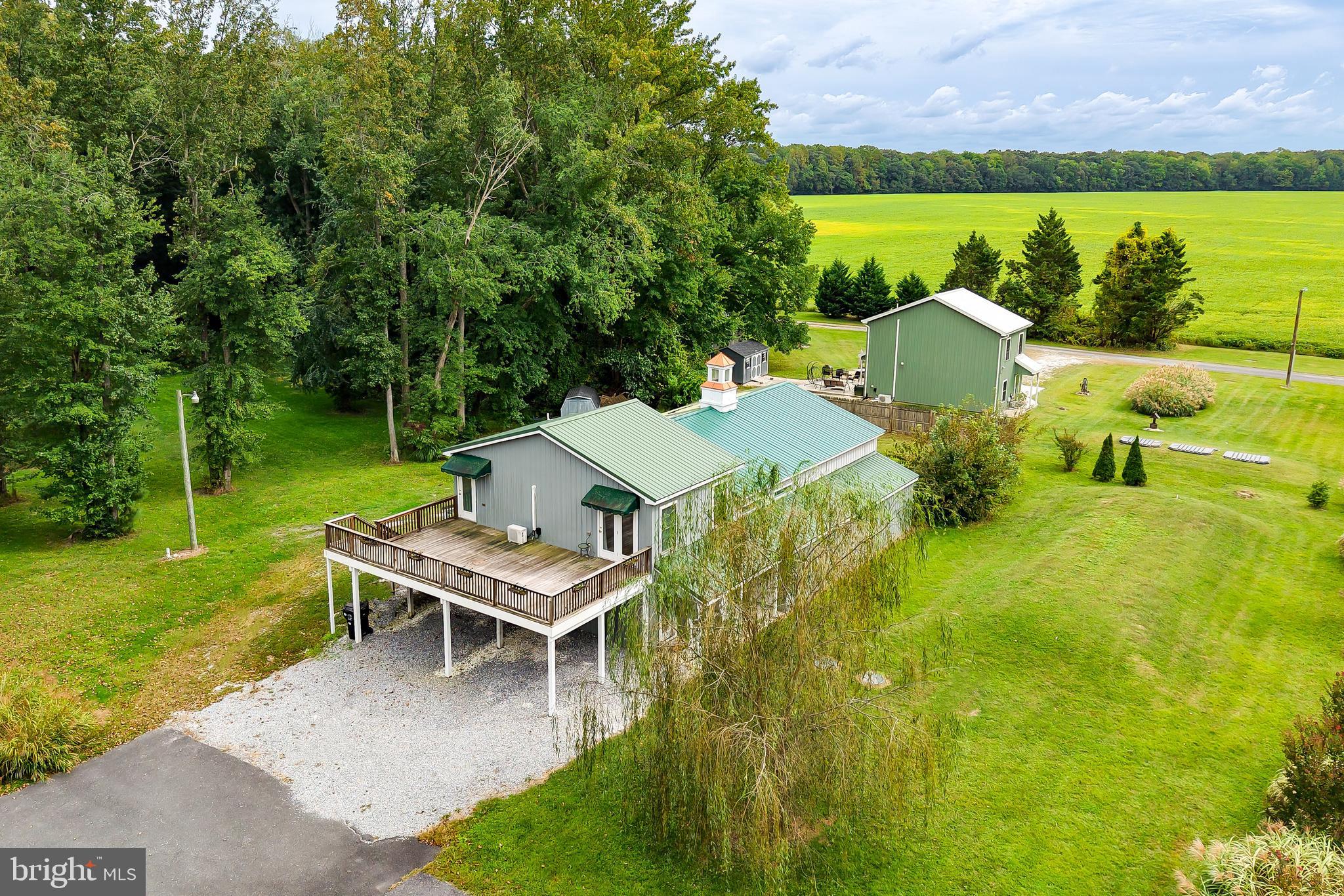 18897 Sand Hill Road Milton, DE 19968 - Photo 3 of 51 a view of a ocean with a table and chairs under an umbrella